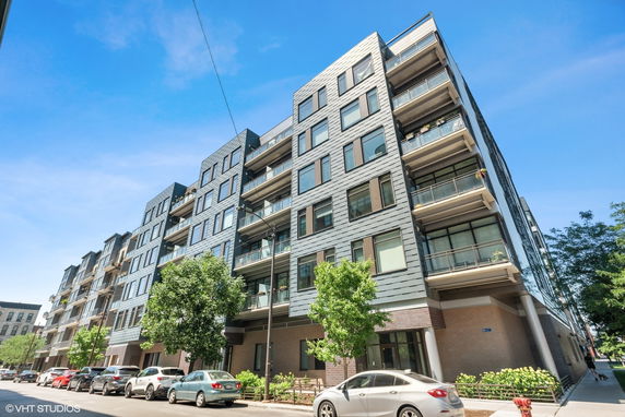 Front view of a multi-story residential building with balconies.