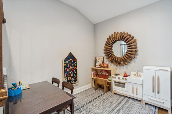 Indoor play area with children's furniture and toys.