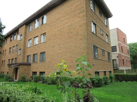 Front view of a multi-story brick apartment building.