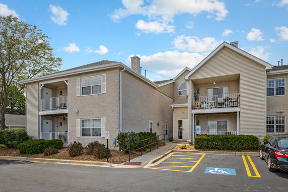 Front view of a multi-story residential building with balconies.