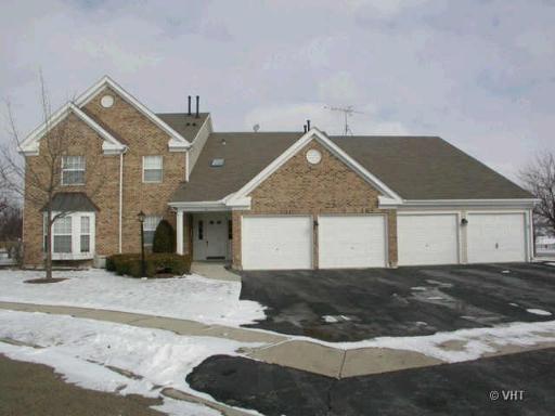 Front view of a two-story house with a three-car garage.