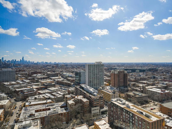 Panoramic view of an urban area with multiple buildings and a clear blue sky.