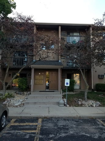 Front view of a multi-story residential building with balconies.