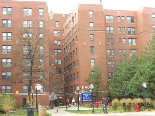 Front view of a multi-story brick apartment building.