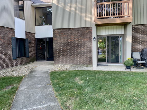 Front view of a residential building with brick and siding exterior.