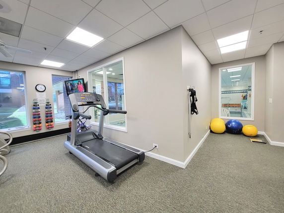 Indoor gym area with exercise equipment and fitness accessories.