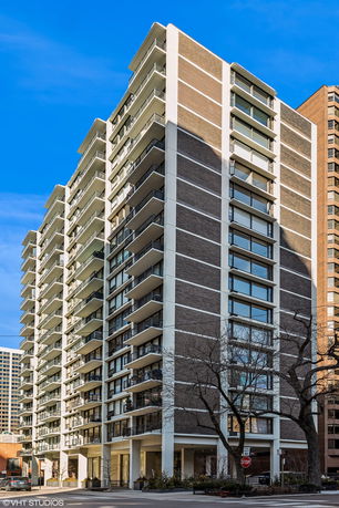 Front view of a multi-story residential building with balconies.