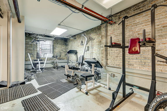 Indoor gym area with various exercise equipment.