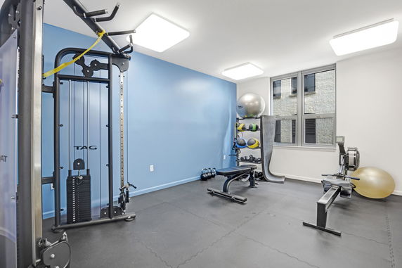 Interior view of a fitness room with exercise equipment.