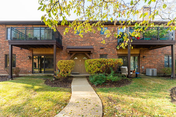 Front view of a two-story brick building with balconies.