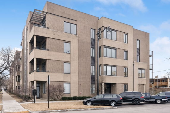 Front view of a multi-story apartment building with balconies.