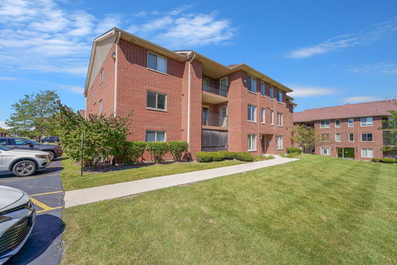 Front view of a three-story brick apartment building.