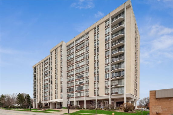 Front view of a multi-story residential building with balconies.