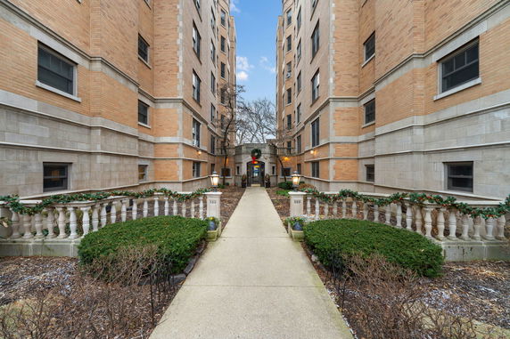 Front view of a multi-story brick apartment building.