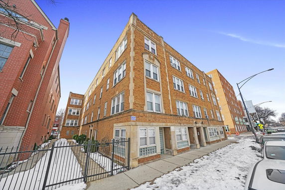 Front view of a multi-story brick apartment building.