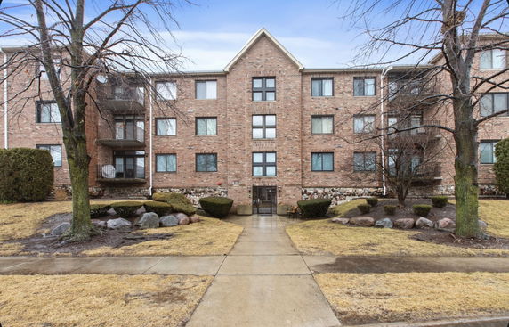 Front view of a multi-story brick apartment building.