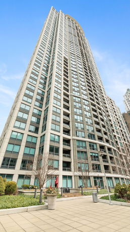 Front view of a high-rise residential building with numerous windows and balconies.