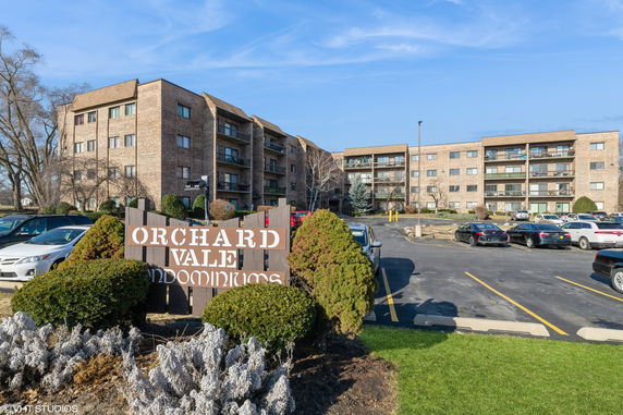 Front view of Orchard Vale condominiums showing a multi-story brick building.