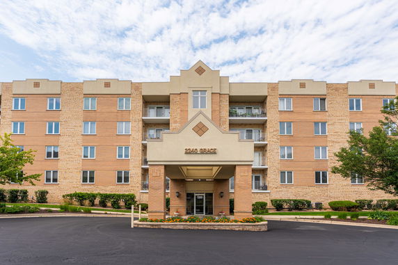 Front view of a multi-story building with a central entrance.