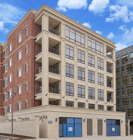 Front view of a multi-story building with brick and stone facade.