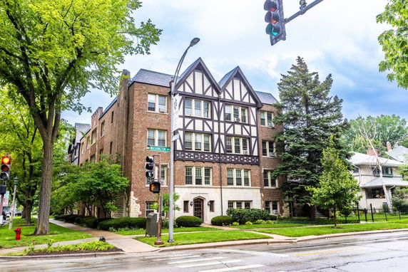 Front view of a multi-story brick building with Tudor-style facade.