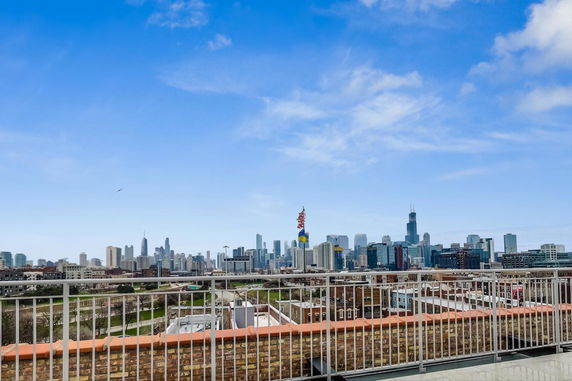Panoramic view of a city skyline from a rooftop perspective.