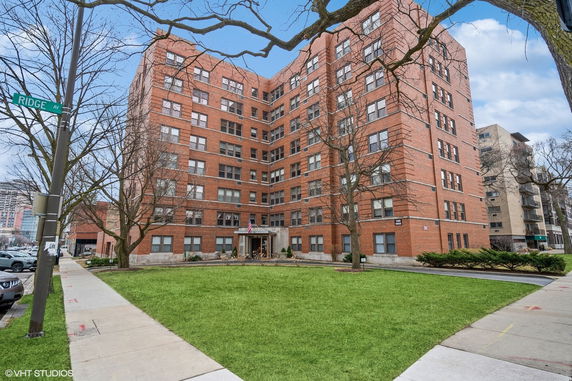 Front view of a multi-story brick apartment building.