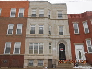 Front view of a multi-story brick building.