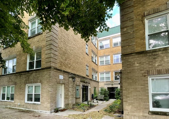 View of a multi-story brick building with multiple windows.
