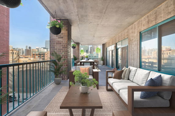 Outdoor terrace with seating and dining area overlooking a city skyline.