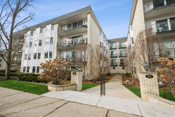 Front view of a multi-story apartment building with balconies.