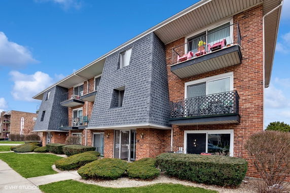 Front view of a multi-story residential building with balconies.