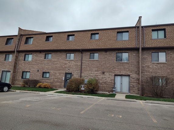Front view of a multi-story brick residential building.