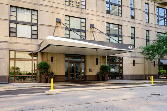 Front view of a multi-story building with a covered entrance.
