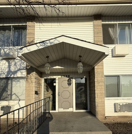 Front view of a building with a covered entrance.