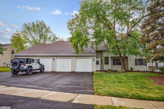 Front view of a two-story house with a three-car garage.