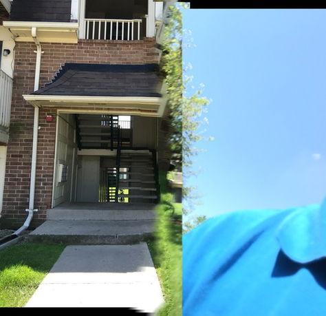 Front view of an apartment building with a visible staircase entrance.