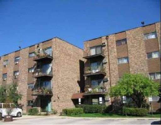 Front view of a multi-story apartment building with balconies.