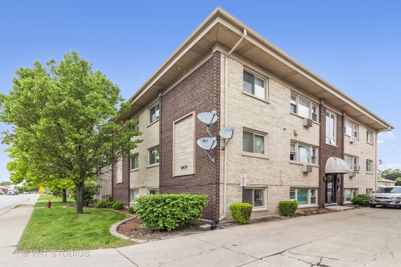 Front view of a multi-story brick apartment building.