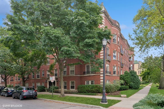 Front view of a multi-story brick apartment building.