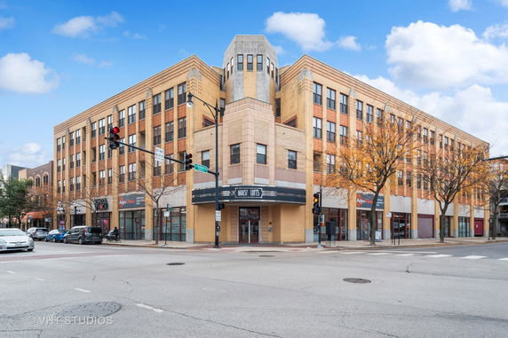 Front view of a multi-story commercial building on a street corner.