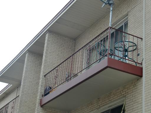 Exterior view of a building with a small balcony.
