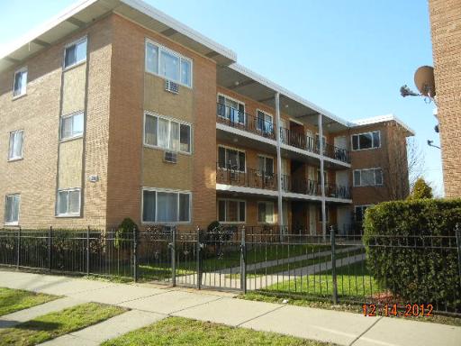 Front view of a multi-story apartment building with balconies.