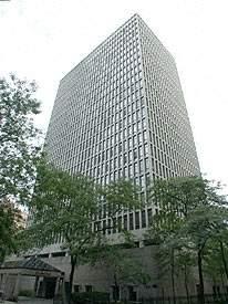 Front view of a high-rise building with a grid-like facade.