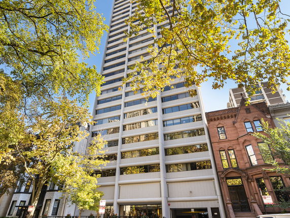 Front view of a tall, multi-story building in an urban setting.