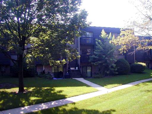 Front view of a multi-story residential building with balconies.