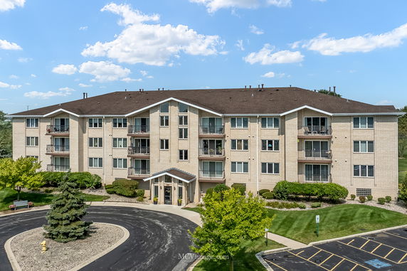 Front view of a multi-story residential building with balconies.