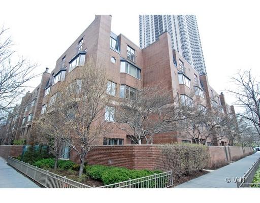 Front view of a multi-story brick apartment building with large windows.