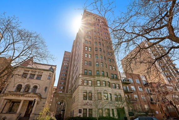 Front view of a tall, multi-story residential building with a classic architectural design.