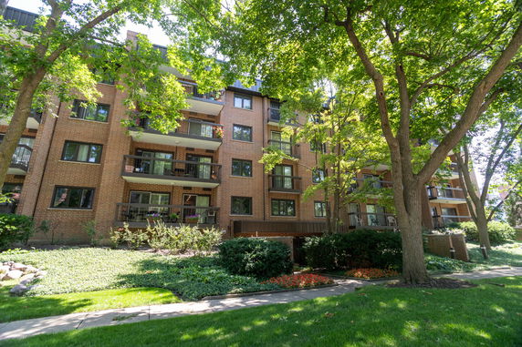 Front view of a multi-story apartment building with balconies.